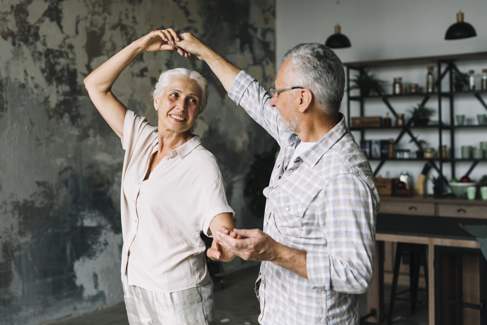 older couple dancing and holding hands