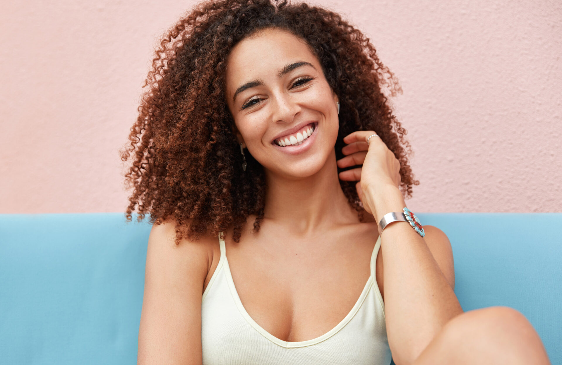 Lady smiling with white teeth and pastel background